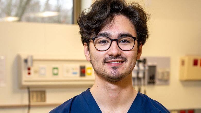 A portrait of Penn State Behrend graduate Grant Oishi in the college's nursing simulation lab.