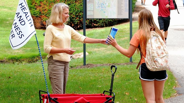 A staff member hands out literature during a Penn State Behrend health fair.
