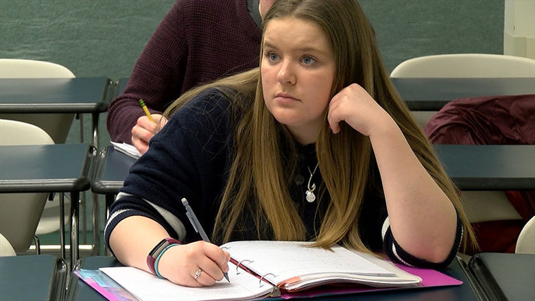 A Penn State Behrend History student attends a lecture.