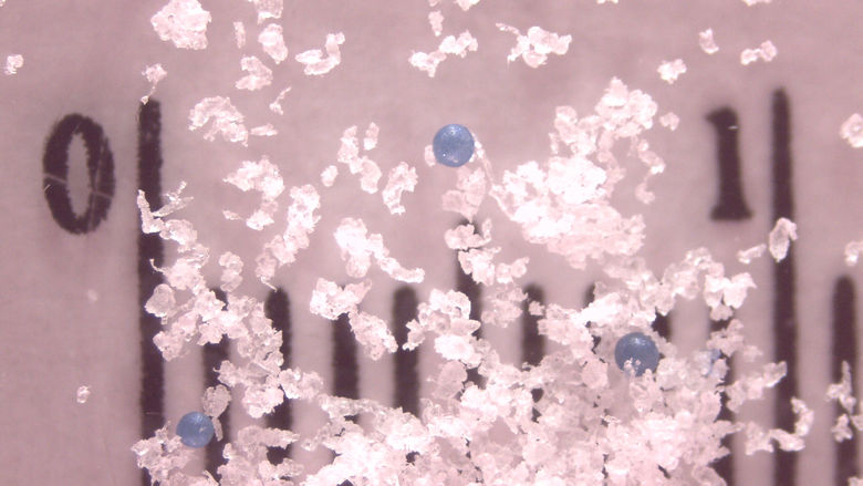Plastic microbeads suspended in water