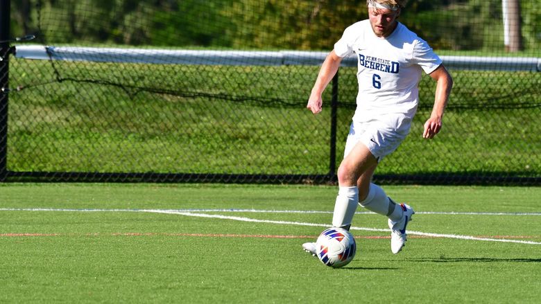 Penn State Behrend soccer player Jonathan Swann prepares to kick the ball.