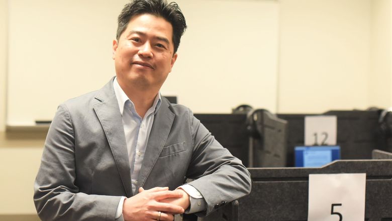 A Penn State Behrend faculty member poses near a computer workstation in the college's Raimy Behavioral Lab.
