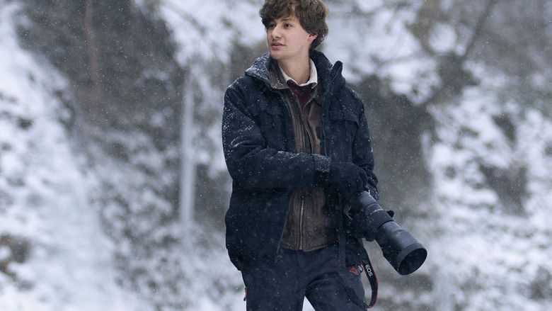 An environmental portrait of Jordan DeLauer, a Penn State Behrend student, holding a camera.