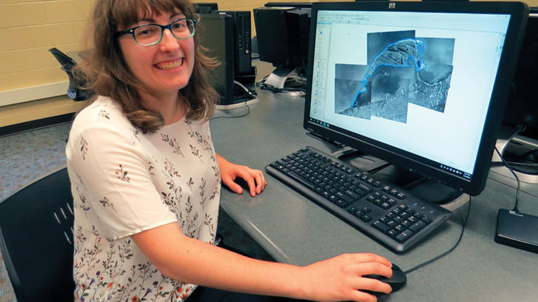 Julia Guerrein, a senior environmental science major, displays GIS mapping software on a computer monitor.