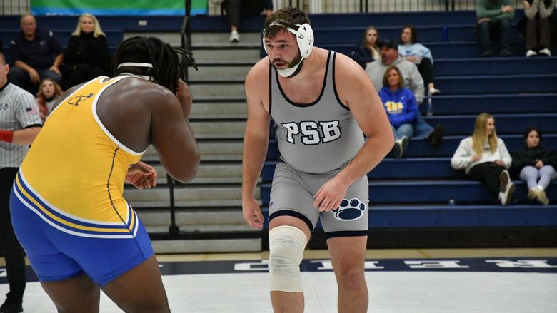 Penn State Behrend wrestler Kyle Trim faces off against an opponent.