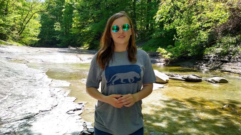 Penn State Behrend student Lauren Cass stands near a creek in Wintergreen Gorge.