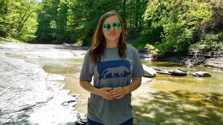 Penn State Behrend student Lauren Cass walks along the creek in Wintergreen Gorge.