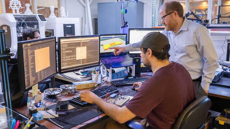 Student and faculty working at computer