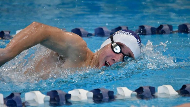 A male swimmer competes in a race for Penn State Behrend.