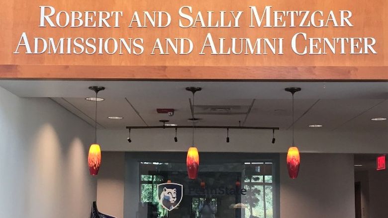 A portrait of Sally and Bob Metzgar, hung above the reception desk at Penn State Behrend's Metzgar Center