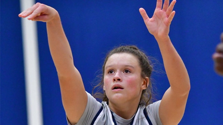 Penn State Behrend basketball player Morgan Altavilla holds her hands up after taking a shot.
