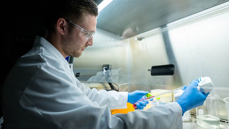 Researcher at hood