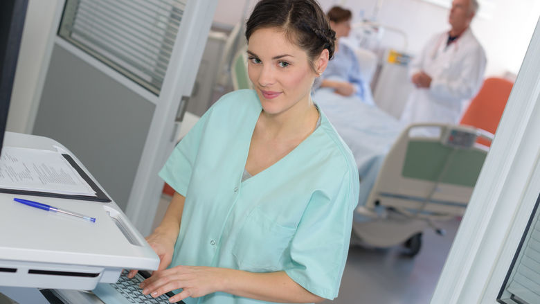 A clinical medical assistant at a work station in a medical office.