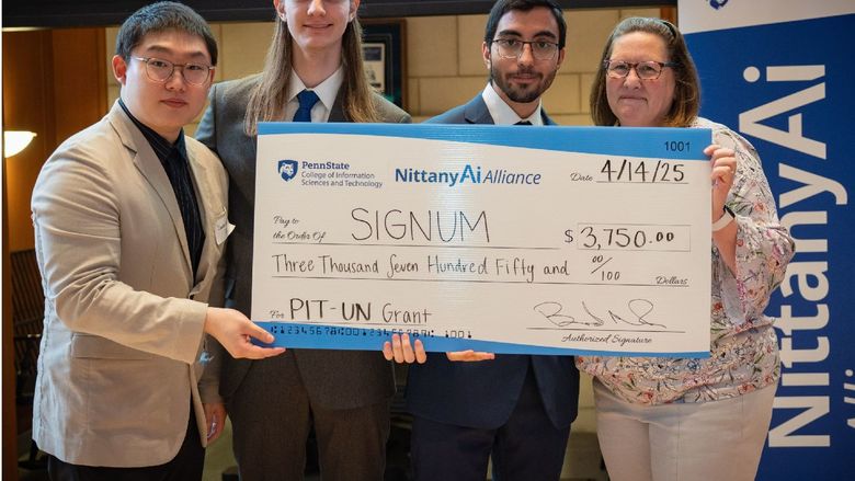 college students display giant check