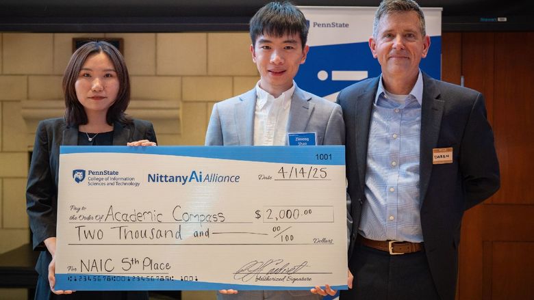 college students display giant check