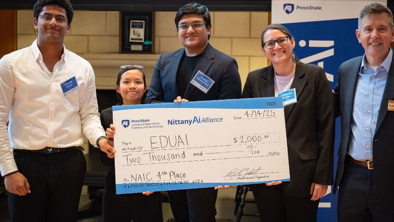 college students display giant check