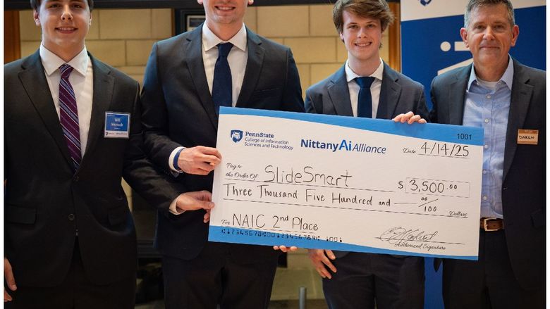college students display giant check