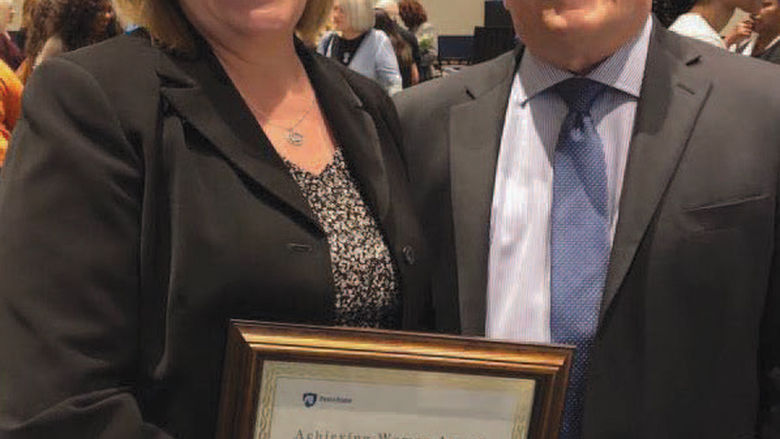 Dr. Kathleen Noce, left, received the Achieving Women Award from Penn State University president Dr. Eric Barron.