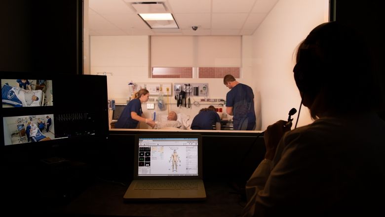 An instructor leads nursing students through a simulation at Penn State Behrend.