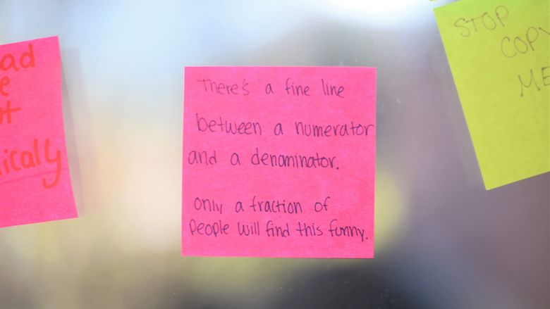 A close-up of a Post-It Note in the Otto Behrend Science building