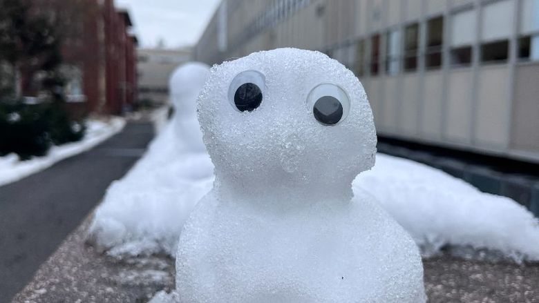 A small snowman with googly eyes