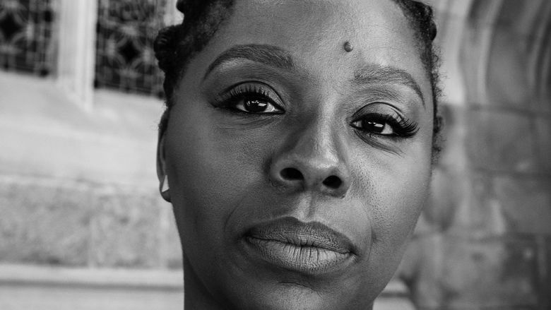 A black-and-white photo of Patrisse Cullors, co-founder of the Black Lives Matter movement.