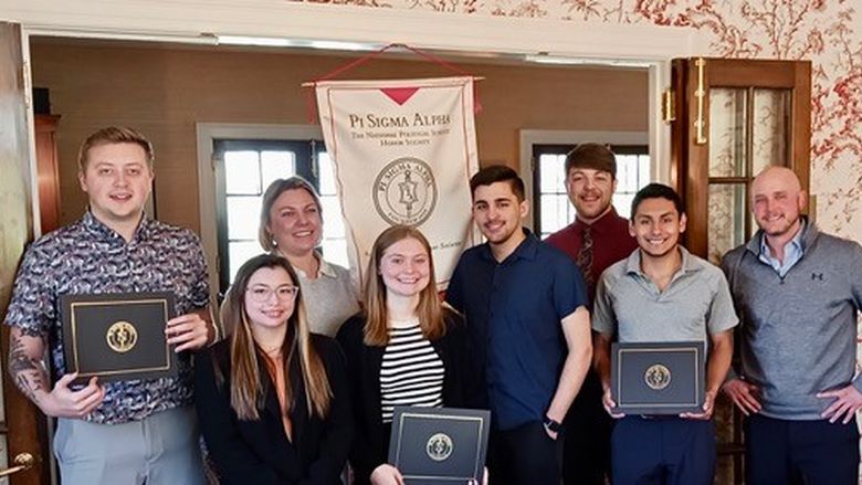 New members join old members at the April 2024 initiation into the Penn State Erie chapter of the Pi Sigma Alpha national political science honor society.
