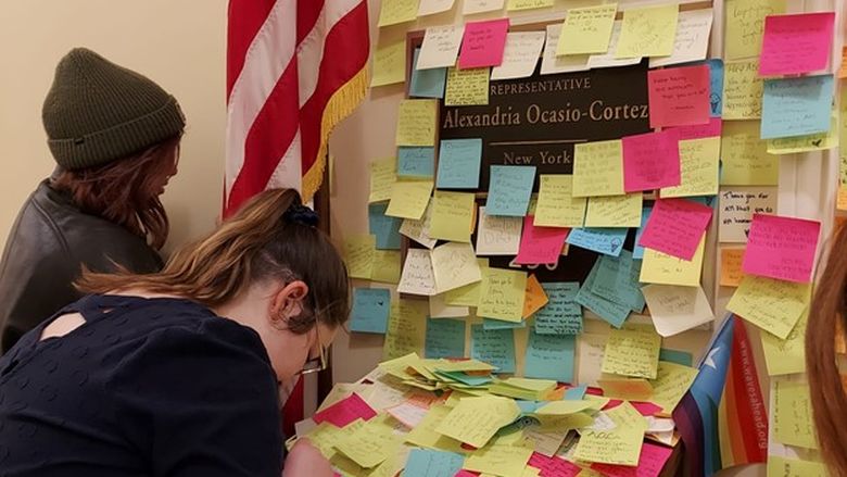 Students leave messages for Representative Alexandria Ocasio-Cortez at the Cannon House Office Building