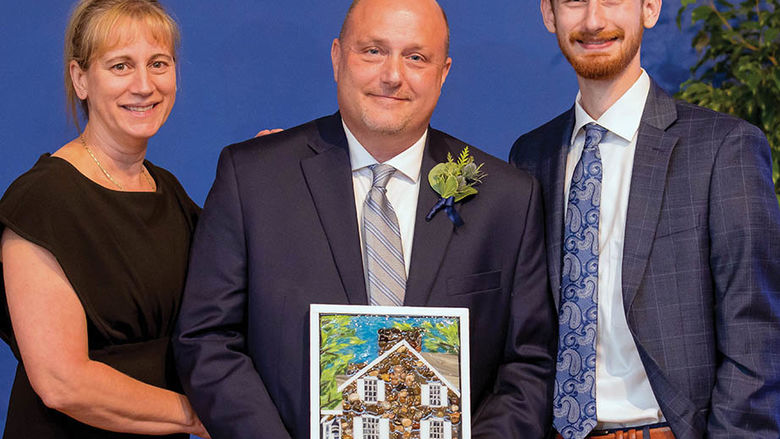 Steven Bugajski, center, at the awards ceremony with his wife, Yvette, and son, Adam, a current Behrend student majoring in Project and Supply Chain Management and Management Information Systems.