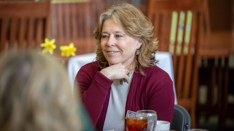 woman smiling at table