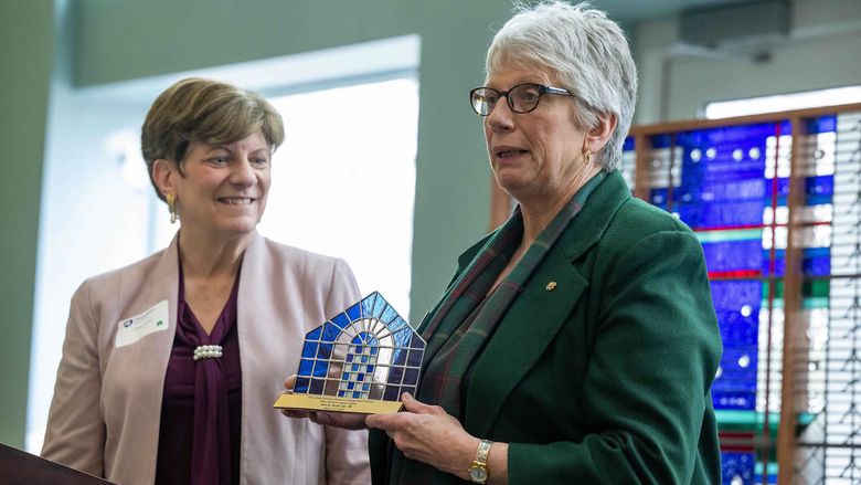 Ann Scott and Priscilla Hamilton holding 2023 Mary Behrend Award . 