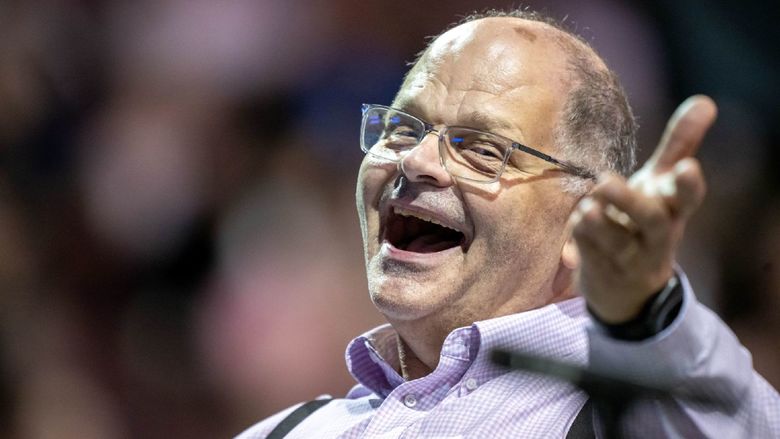 Gary Viebranz, teaching professor of music at Penn State Behrend, smiles while conducting the commencement band.