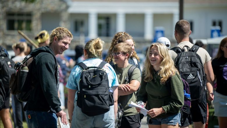 Students gather in groups to talk at the Penn State Behrend Discovery Fair.
