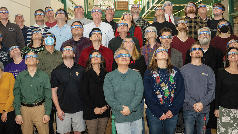 School of Science staff trying out the eclipse glasses.