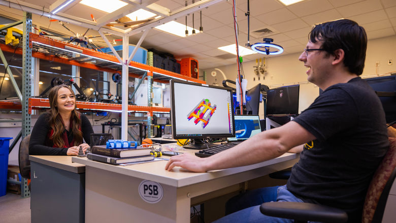 Two students work at a computer station in the Meehl Innovation Commons at Penn State Behrend.