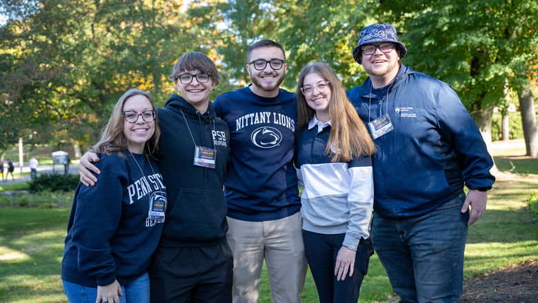 Group of five Behrend alumni smiling