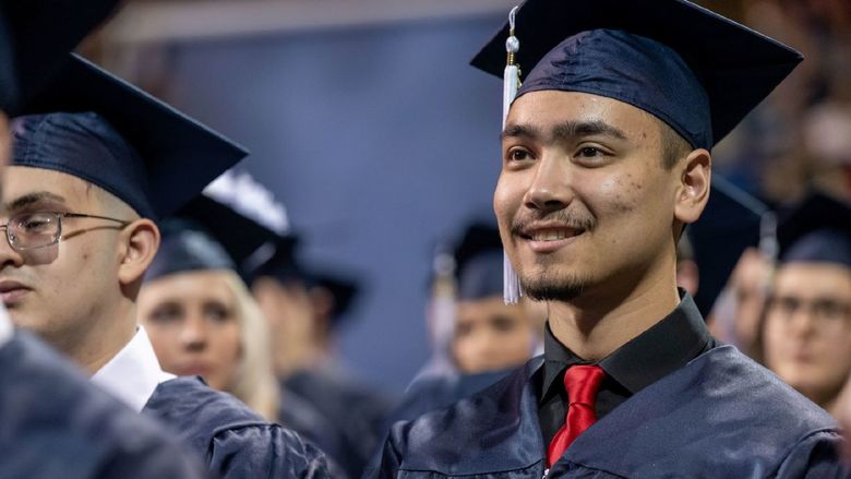 A student smiles during Penn State Behrend's spring 2022 commencement program.