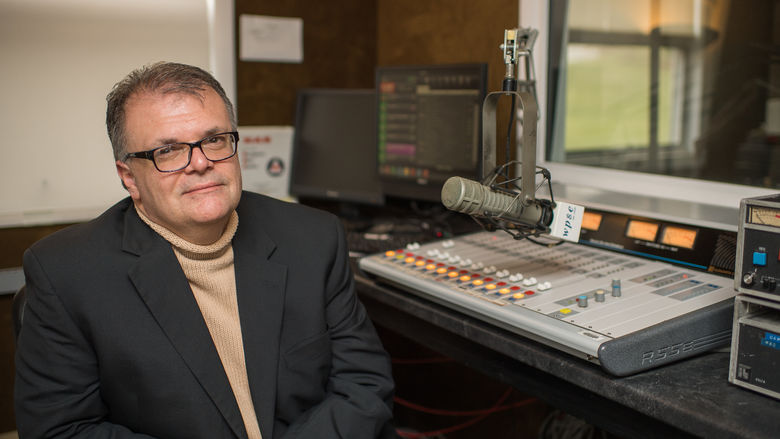 Joe Martin, the general manager of WPSE radio at Penn State Behrend, sits in the station's control room