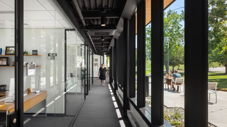 A glass-walled hallway at Penn State Behrend's Federal House
