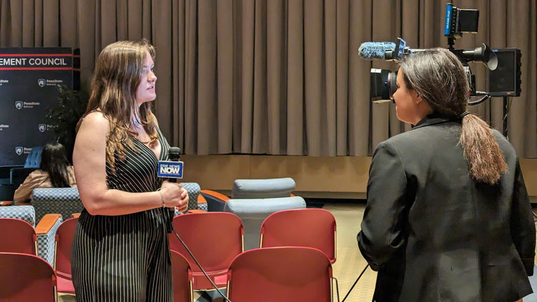 Student, Lauren Cass, is interviewed by TV reporter at Blue Chair chat