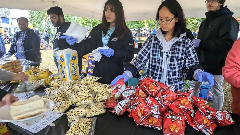 Penn State Behrend students serve food at the Our West Bayfront festival in Erie.