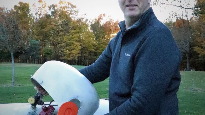 Ron Forbes poses with the ProDomeSeal, which he designed to prevent birds from nesting on propane tanks.