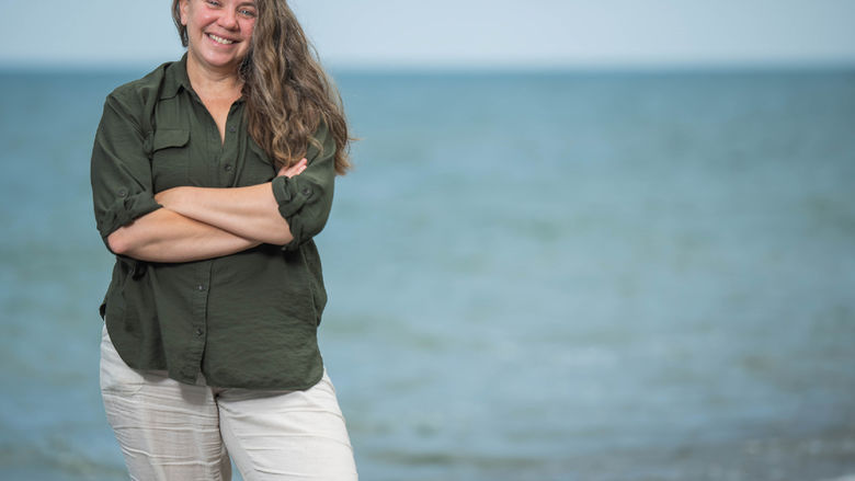 Sherri "Sam" Mason, director of sustainability at Penn State Behrend, stands on a beach in Erie, Pa.