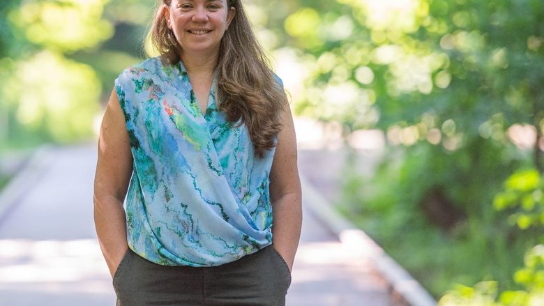 Sam Mason, director of sustainability at Penn State Behrend, stands on a boardwalk on a Wintergreen Gorge trail.