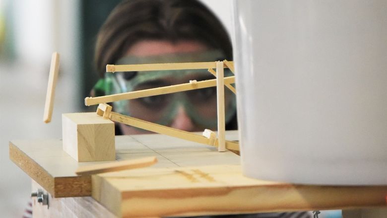 A piece of wood pops off a model bridge during the Science Olympiad at Penn State Behrend.