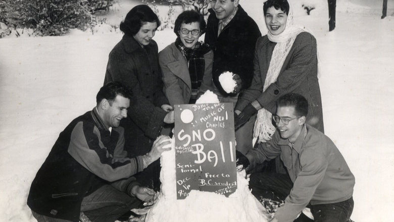 Students gather around a promotional sign for the Snow Ball dance at Behrend Center.