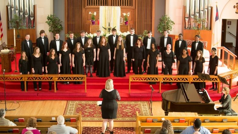 The Penn State Behrend choir performs in a church.