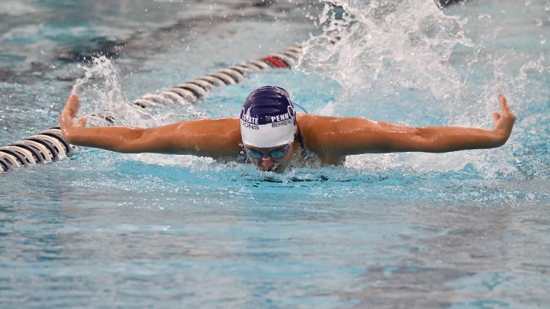 A female swimmer competes in a butterfly event.