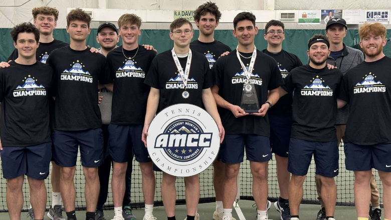 The Penn State Behrend men's tennis team poses with the AMCC championship banner.