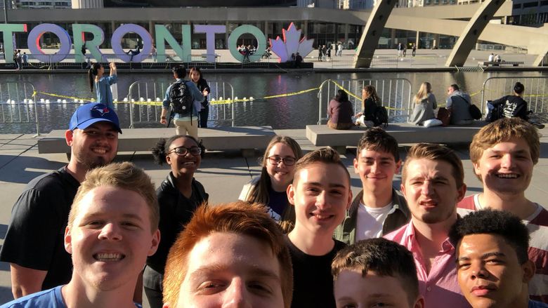 The 2018 group of Penn State study abroad students on the first day of their political science course in Canada at the Toronto sign in front of City Hall